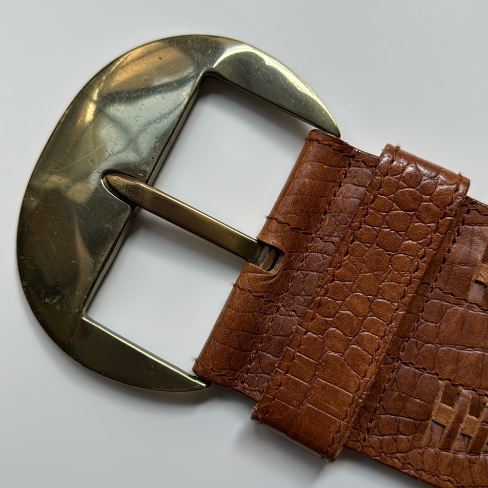 Beautiful large brass buckle leather belt with unique pattern. Size medium.
